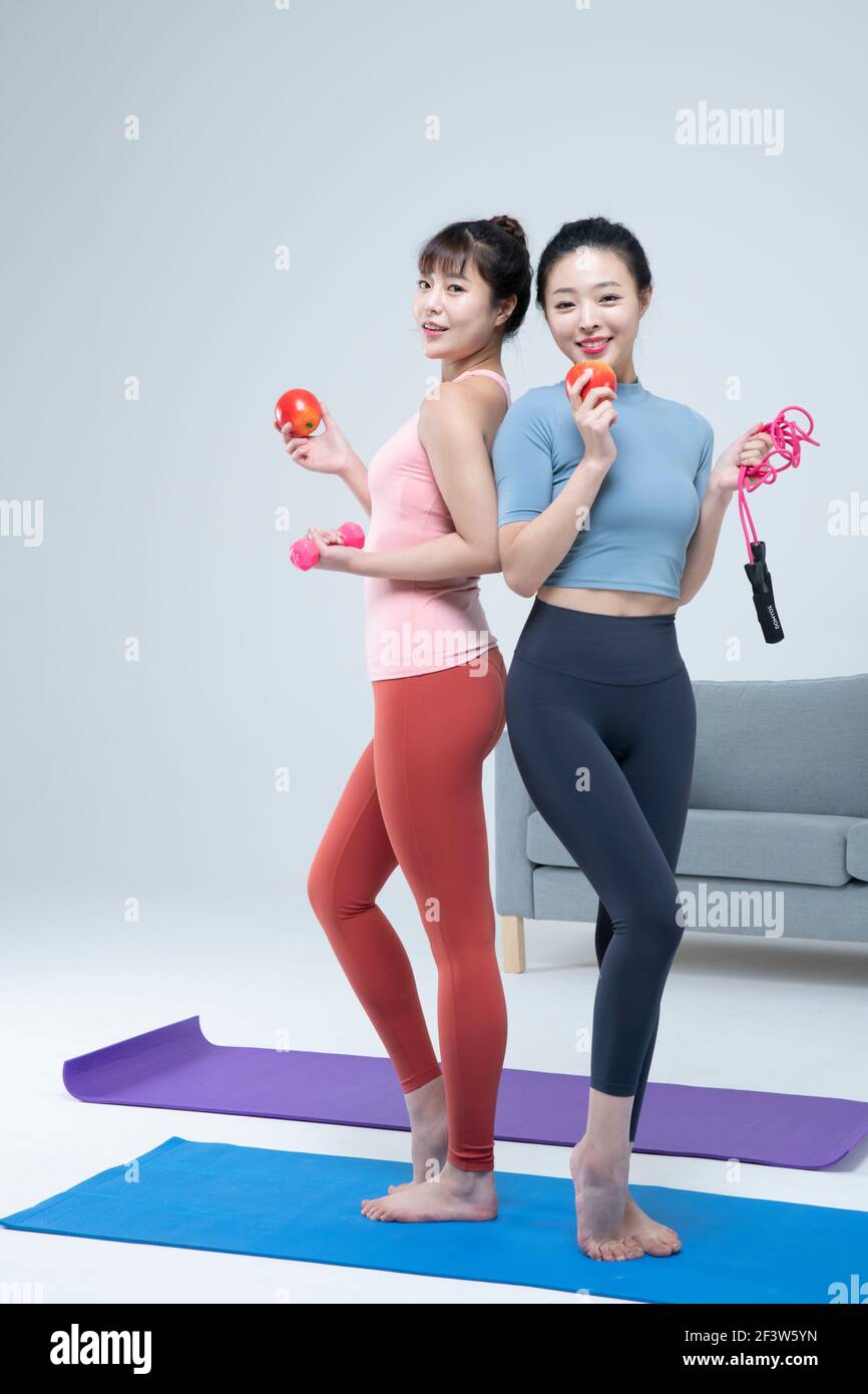 two fit Asian young women home training concept wearing sports top