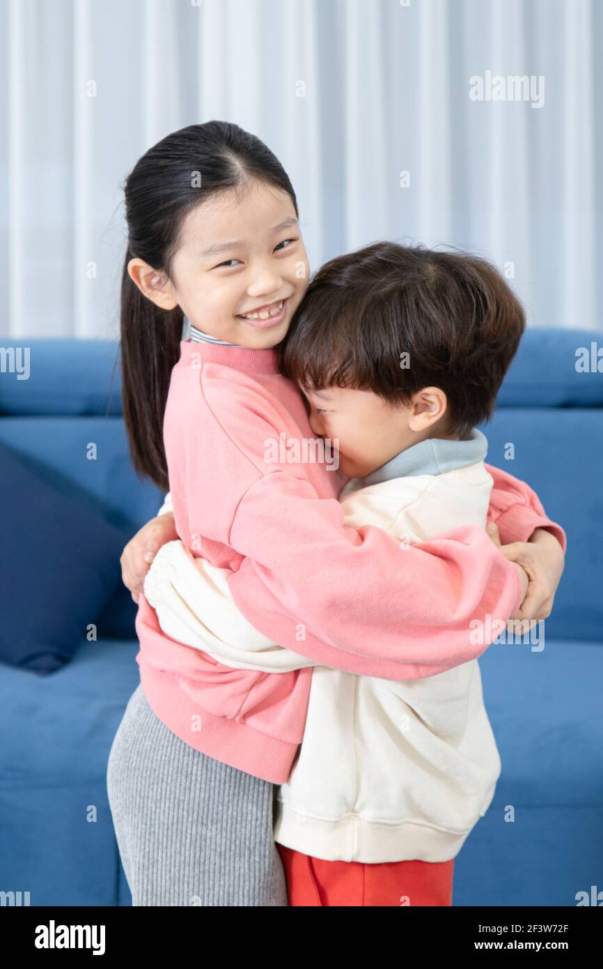 Asian children, sister and brother hugging after fight Stock Photo Alamy