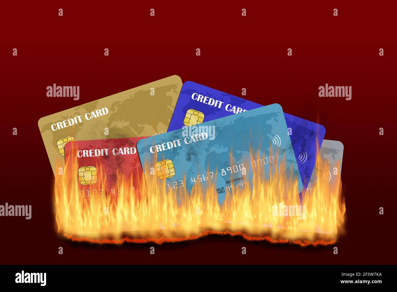 Multiple credit cards burning with rising fire and smoke isolated on red background with copy space. Concept of credit trouble, financial crisis, cred Stock Photo