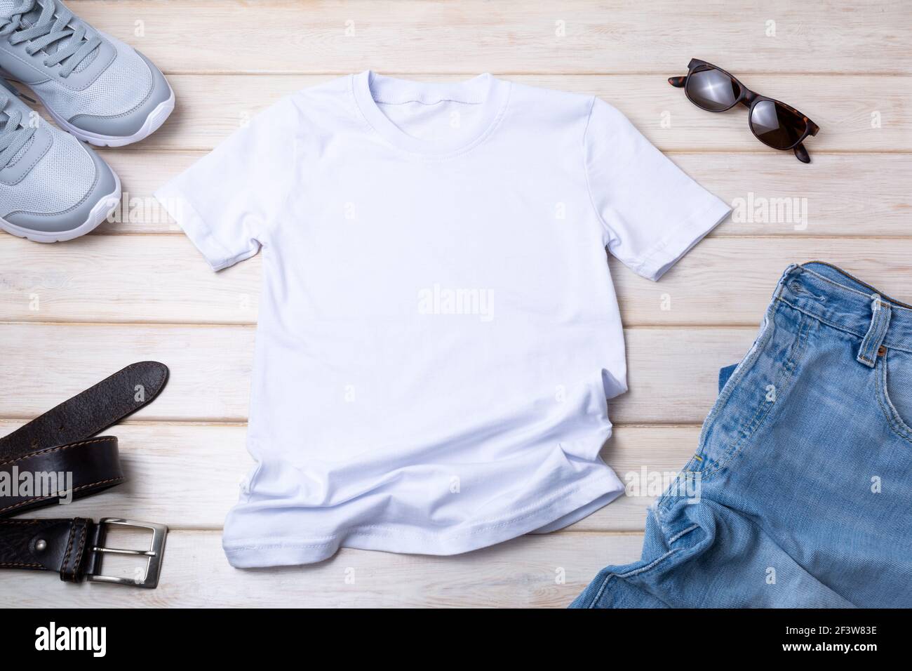 White mens cotton T-shirt mockup with blue jeans, belt, sunglasses. Design t shirt template, tee print presentation mock up Stock Photo