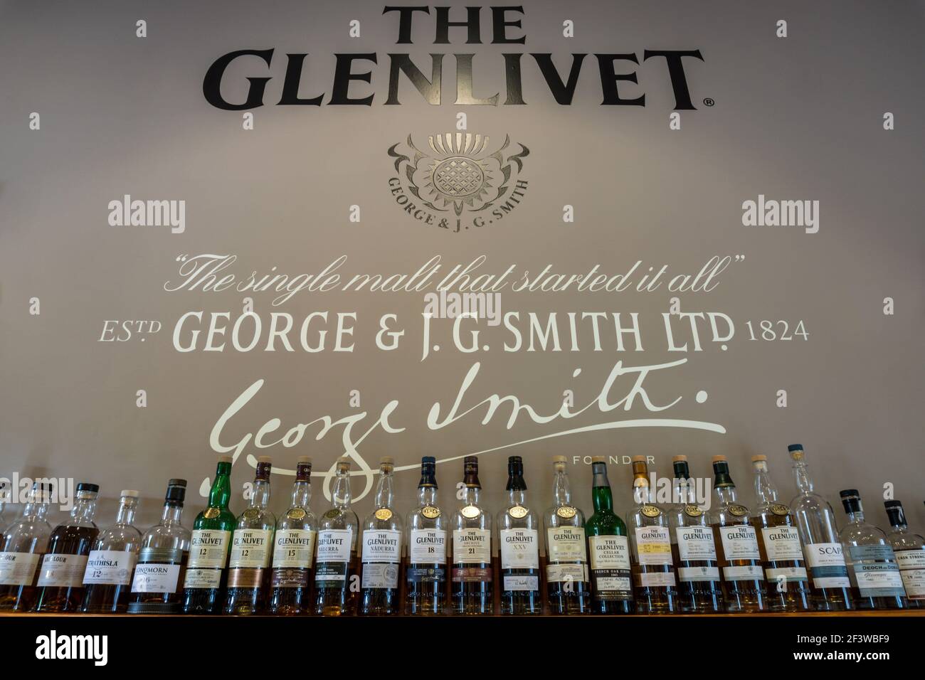 A row of whisky bottles at the Glenlivet Distillery visitor centre in Speyside, Scotland Stock Photo