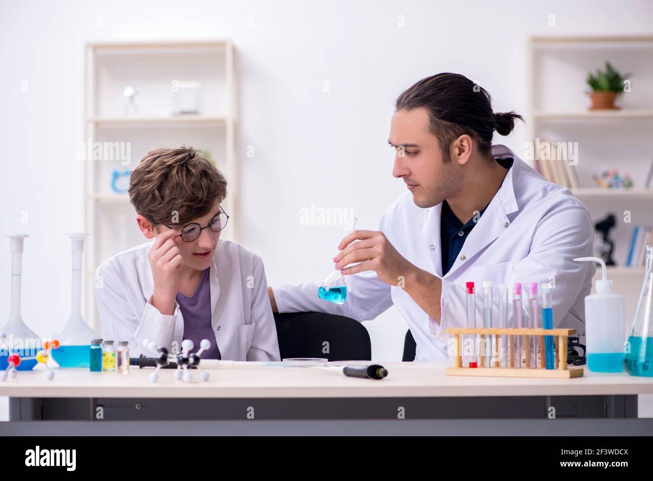 Father's Hidden Lab Young father and son chemists in the laboratory Stock Photo - Alamy