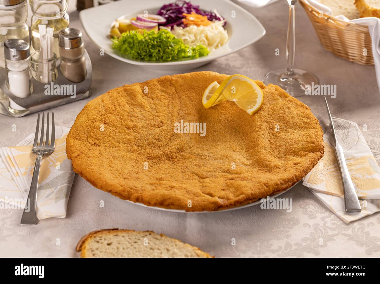 Schnitzel decorated with lemon on the restaurant table Stock Photo