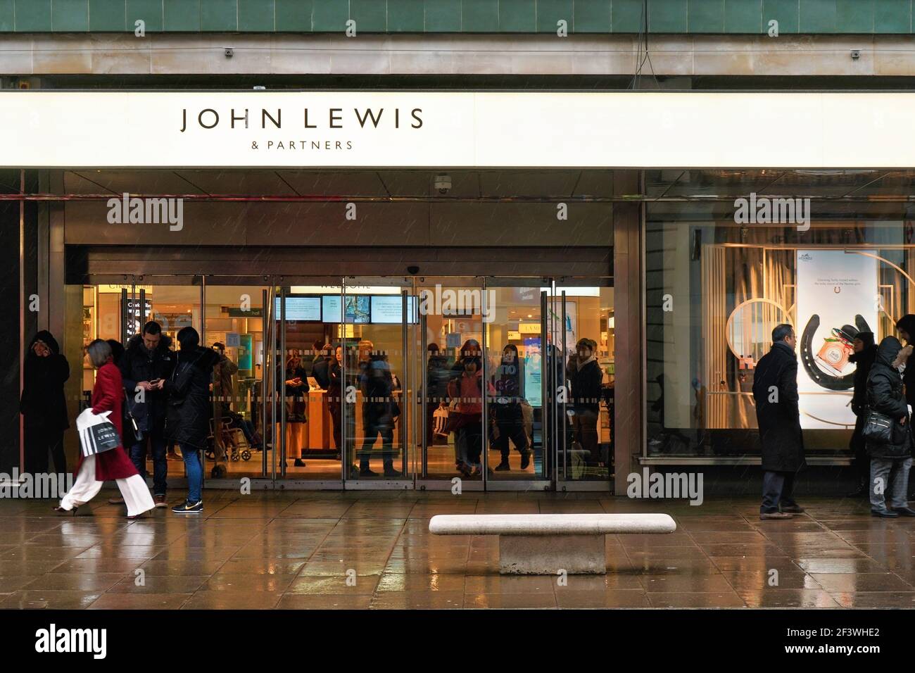 London, United Kingdom - February 01, 2019: Pedestrians walk in front of John Lewis mall entrance at Oxford Street on a rainy day.  It is brand of hig Stock Photo