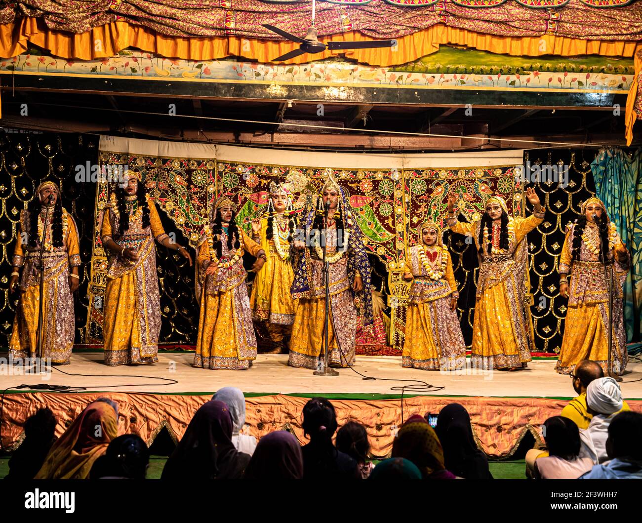 young actor representing krishna and radha marriage on stage with selective focus in subject and added noise and grains. Stock Photo