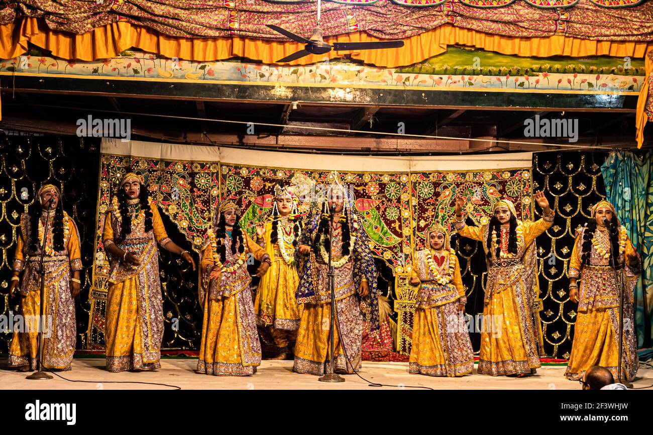young actor representing krishna and radha marriage on stage with selective focus in subject and added noise and grains. Stock Photo