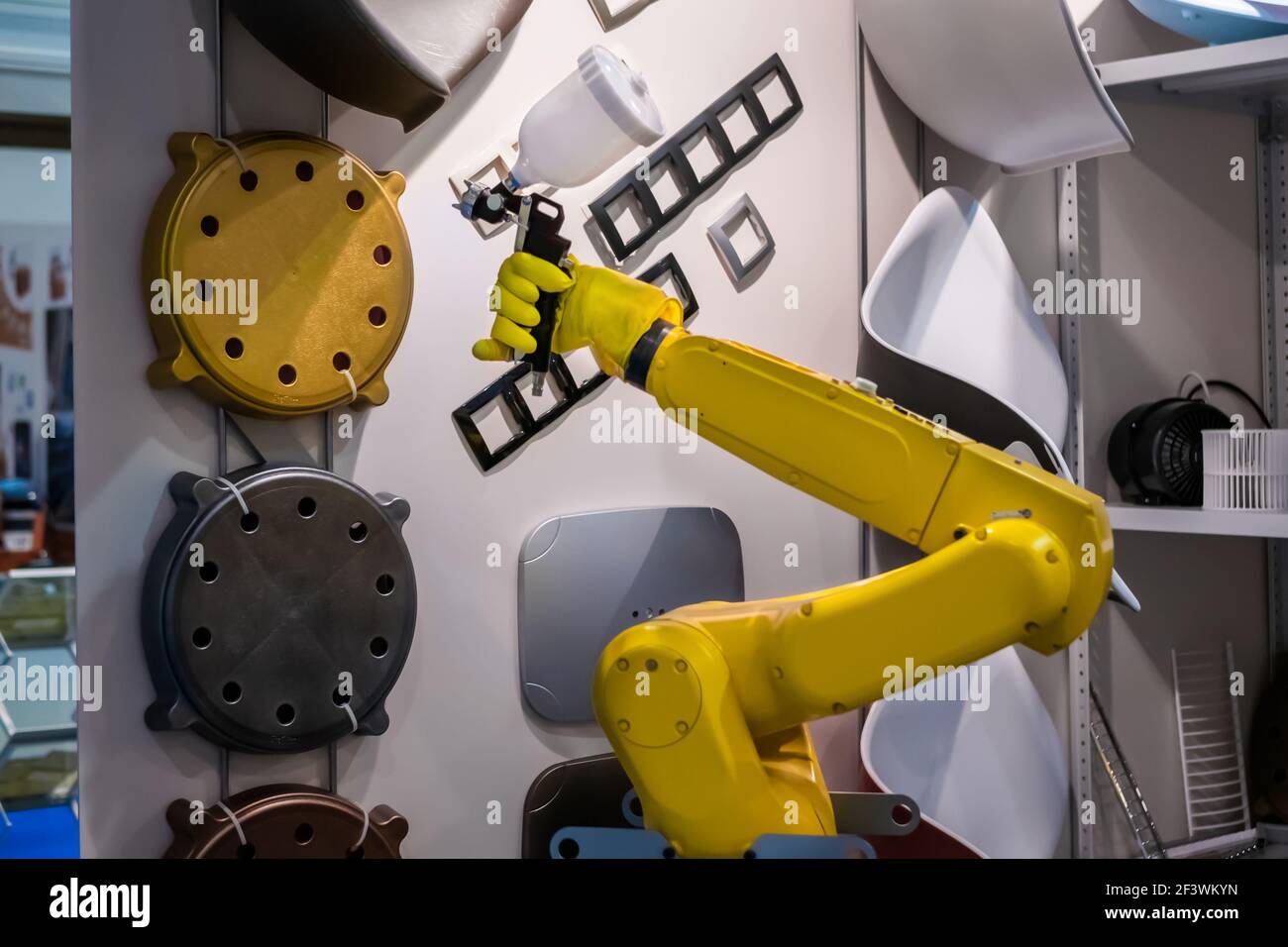 Cuarto Suavemente Capataz Automatic yellow spray painting robotic arm manipulator demonstrates  functionality at smart robot technology exhibition, trade show.  Manufacturing, fu Stock Photo - Alamy
