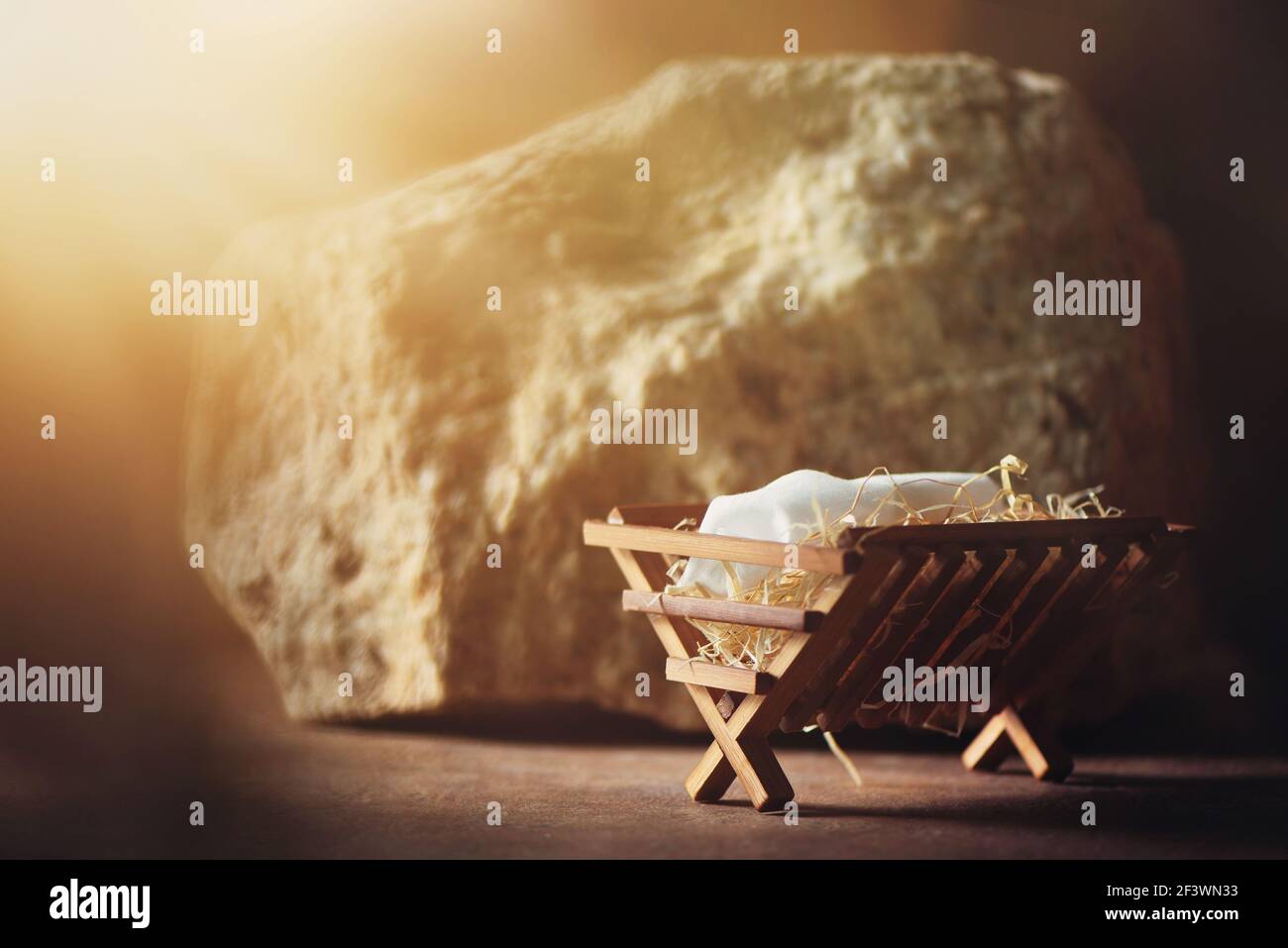 Wooden manger and star of Bethlehem in cave, nativity scene background. Christian Christmas