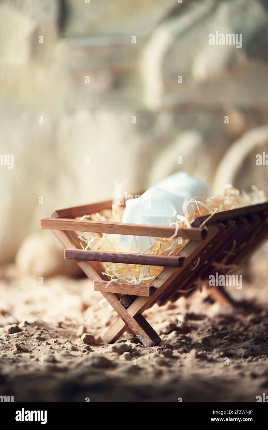 Wooden manger and star of Bethlehem in cave, nativity scene background. Christian Christmas