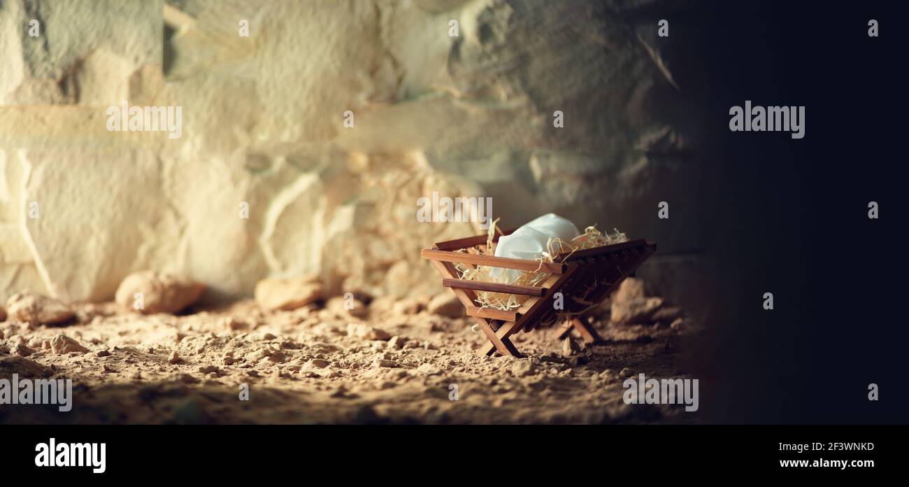 Wooden manger and star of Bethlehem in cave, nativity scene background. Christian Christmas