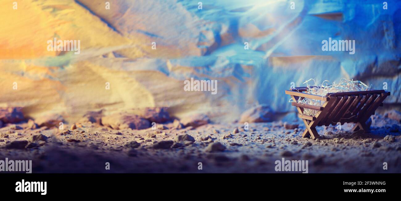 Wooden manger and star of Bethlehem in cave, nativity scene background. Christian Christmas