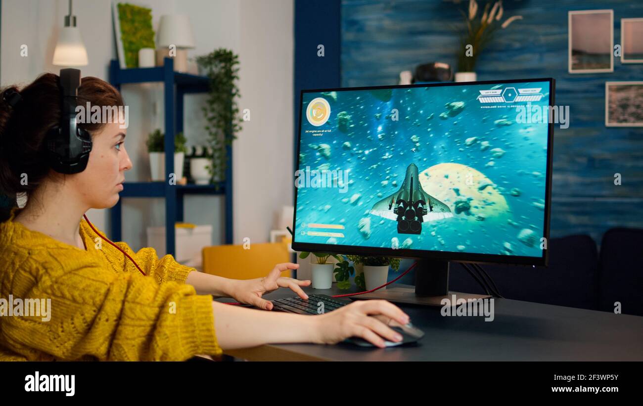 Gamer Using Mic Concentrated gamer puting headset with mic on starting to play space ...