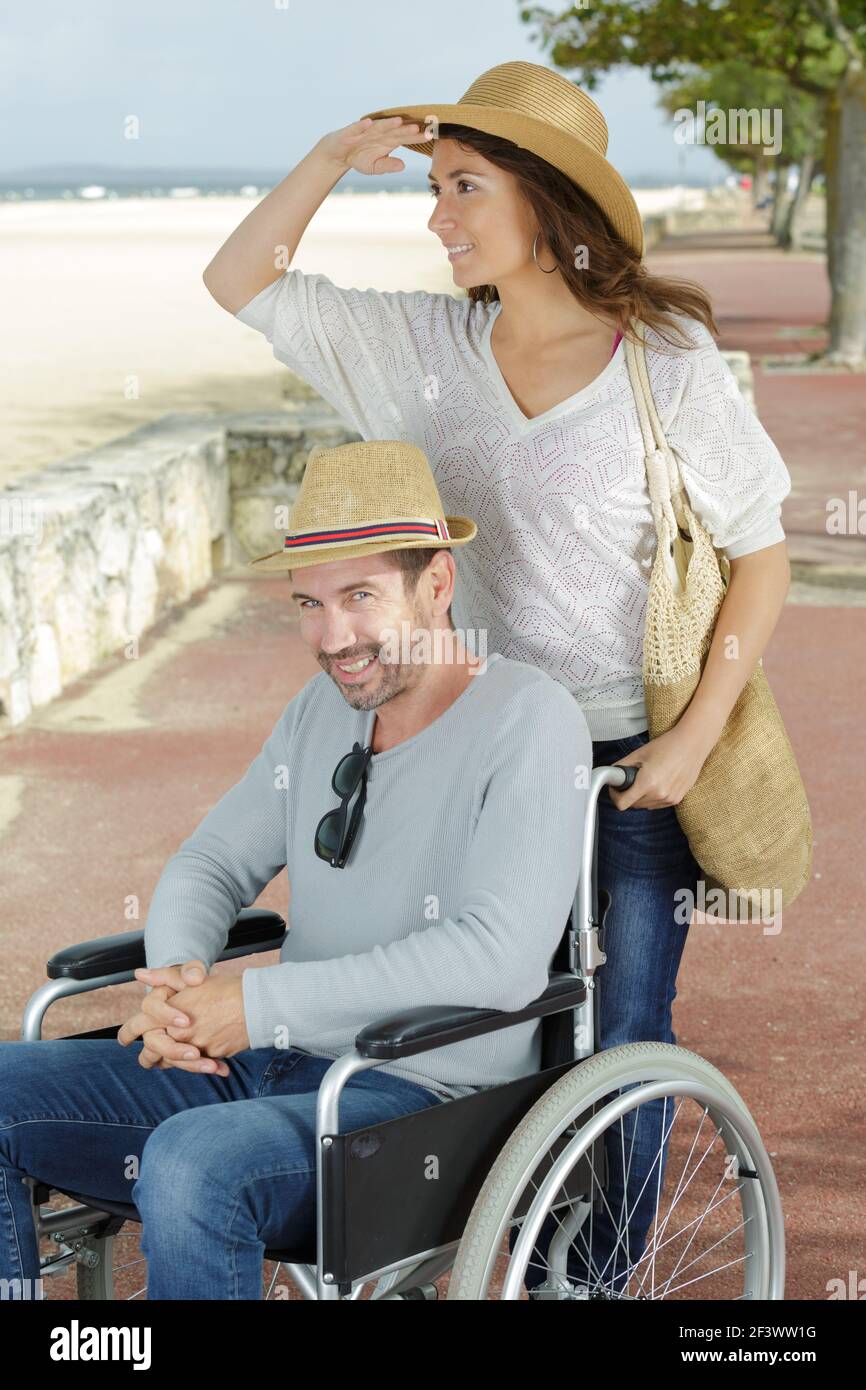 handicapped couple resting on a beach Stock Photo Alamy