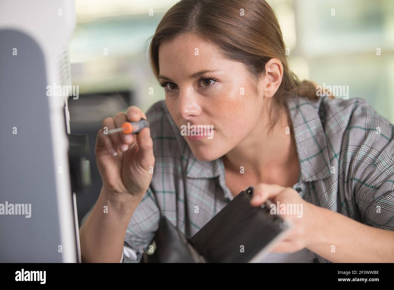 female engineer working with screwdriver Stock Photo - Alamy