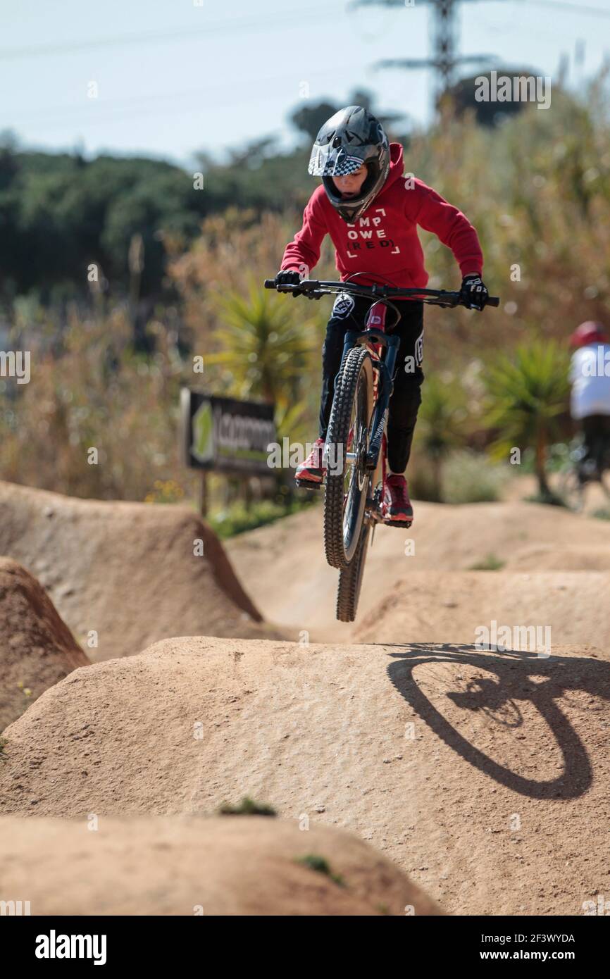 Mountain bike rider performing dirt jumps at La Poma Bike Park near Barcelona, Spain Stock Photo