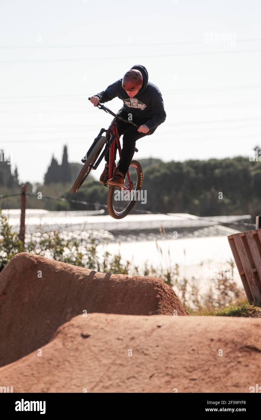 Dirt bike rider performing jumps at La Poma Bike Park near Barcelona, Spain Stock Photo
