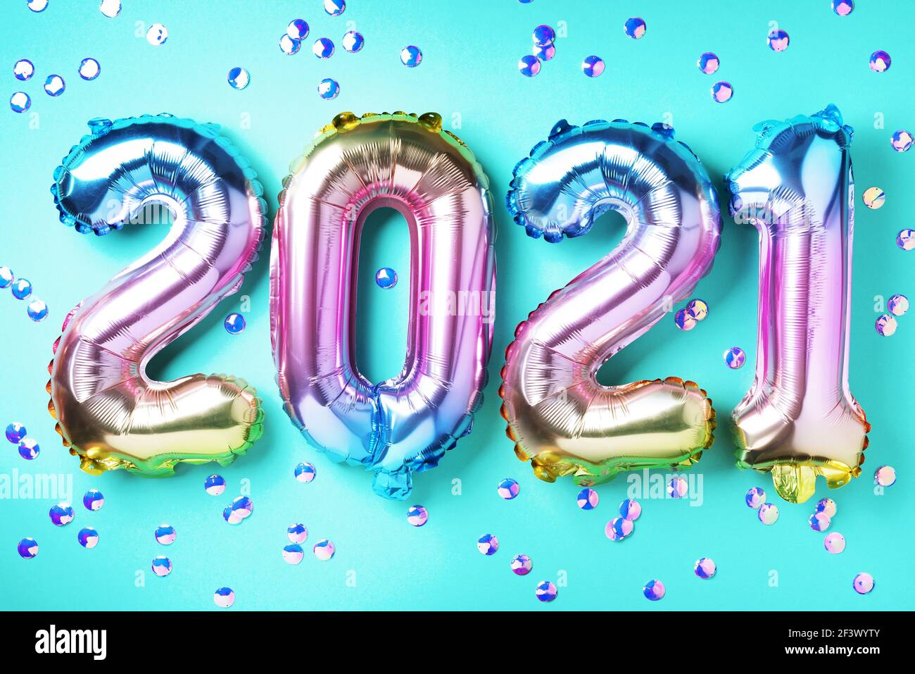 Colorful foil balloons made numbers 2021 on blue background with light ...