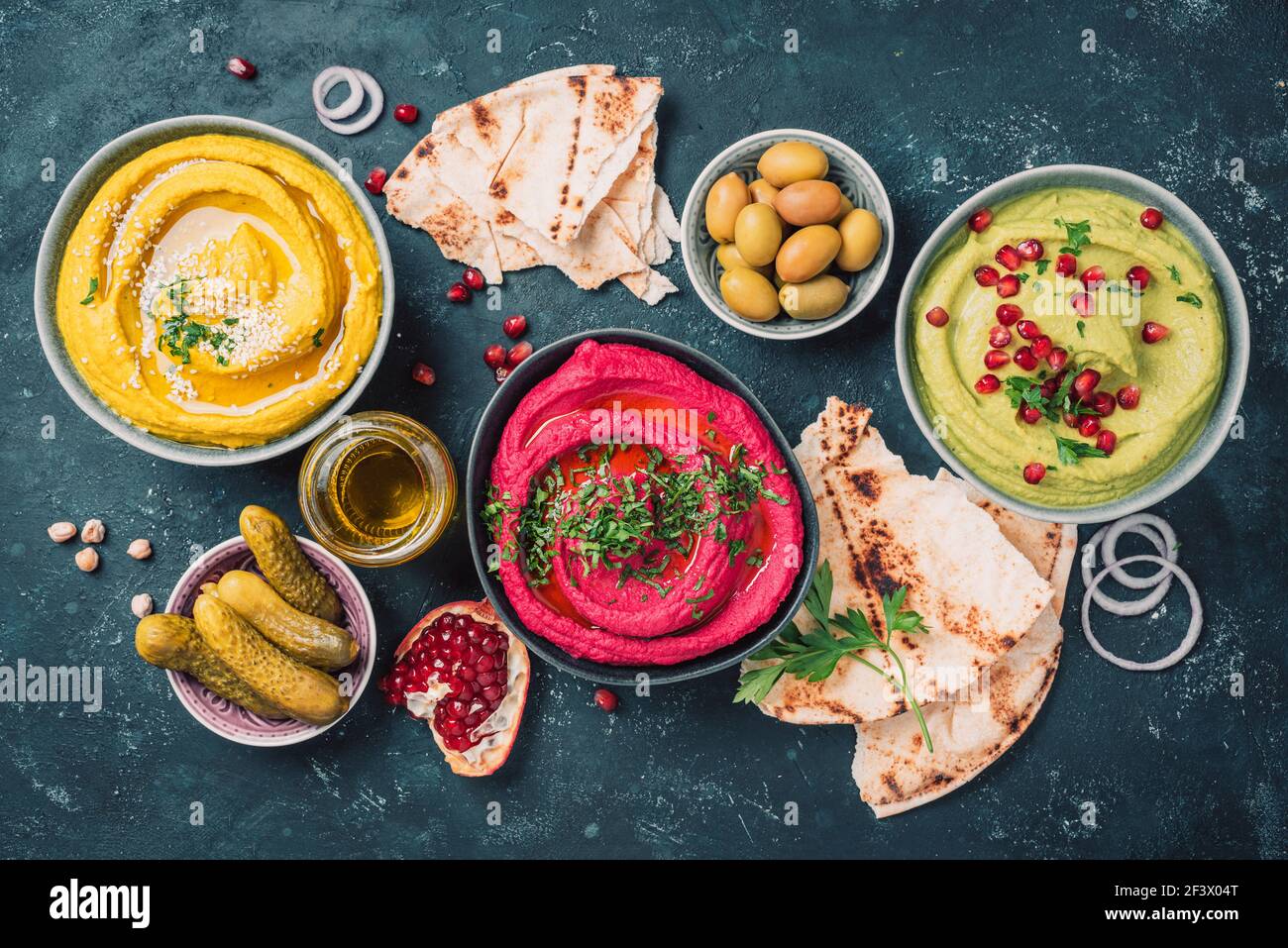 Ingredients for yellow turmeric hummus, green parsley hummus and red