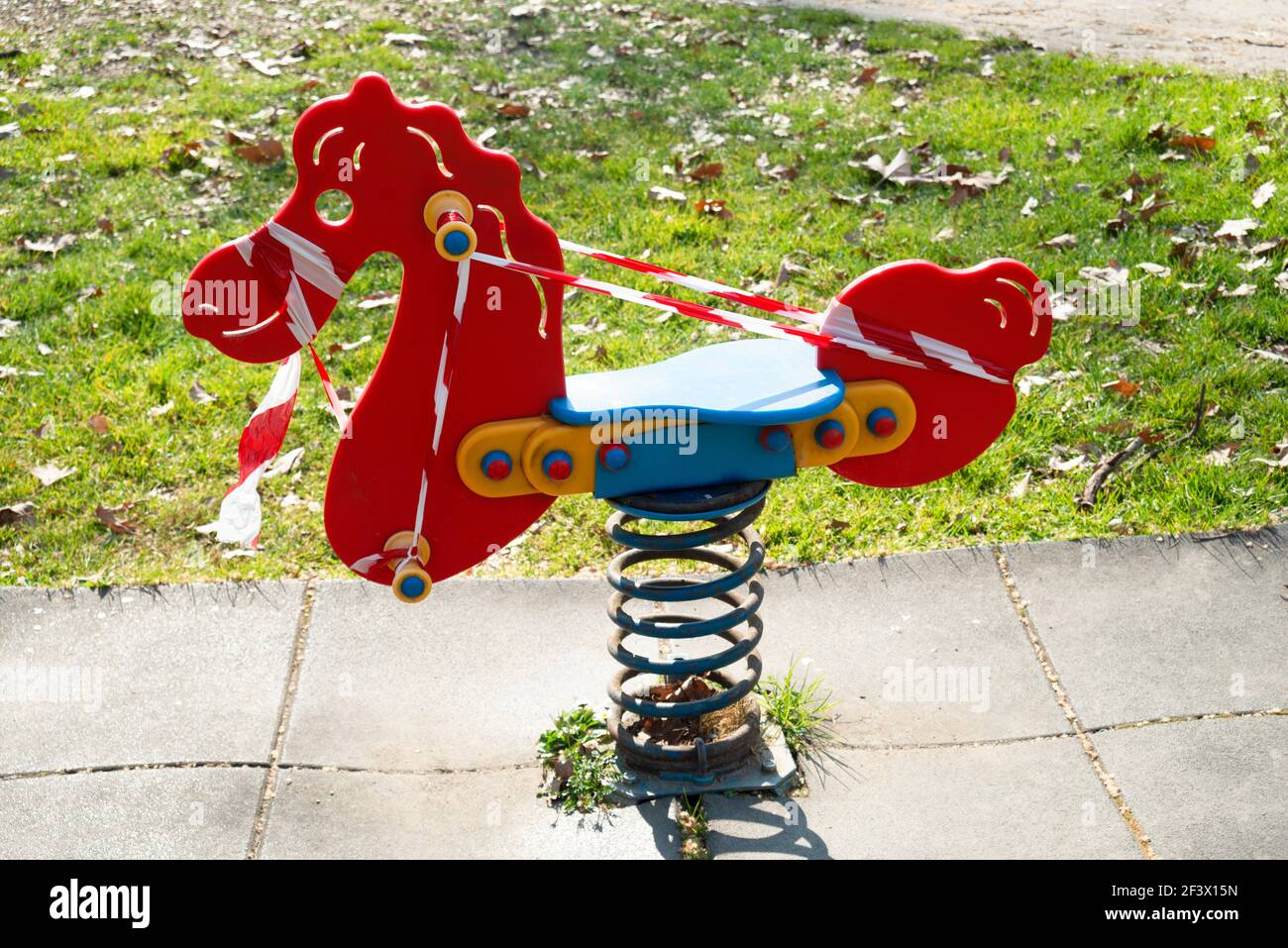 Italy, Lombardy, Crema, Park Children Playground  Closed due to the Covid-19 Virus with a Barrier Tape Stock Photo