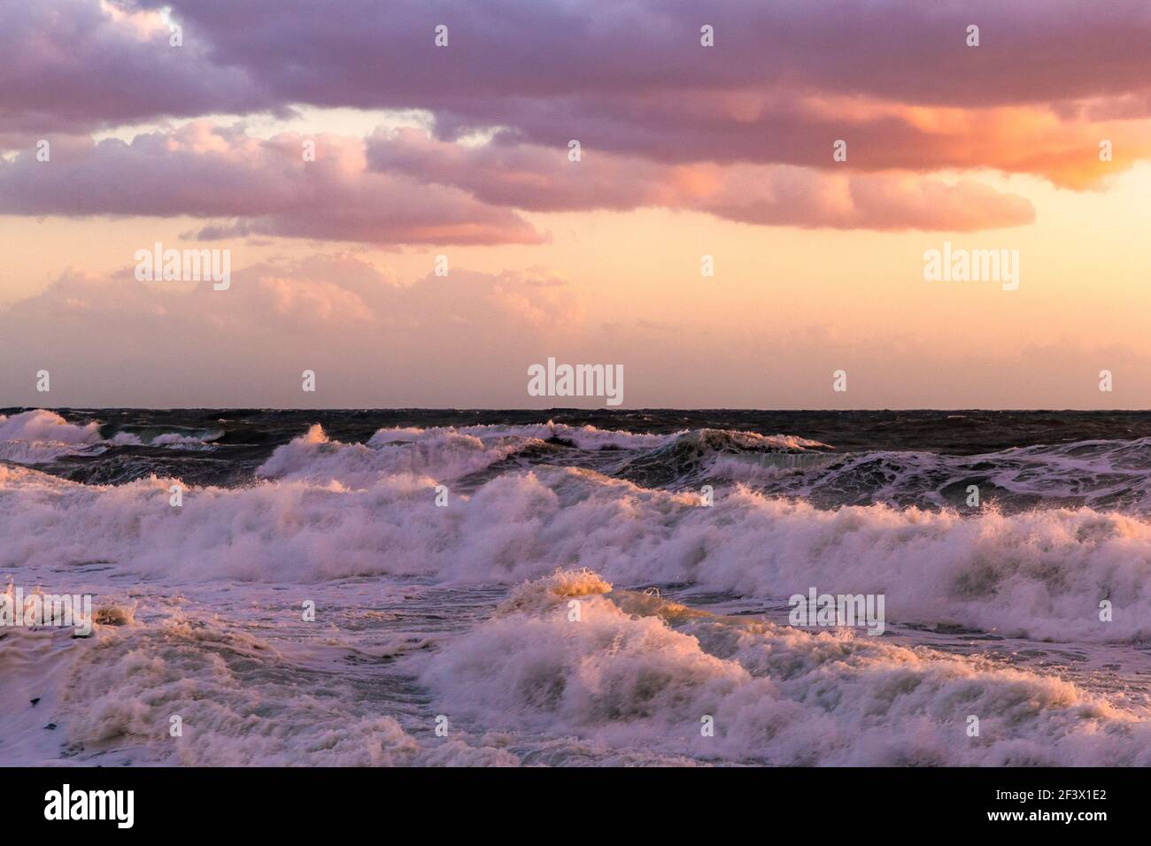 Cloudy sunset at the stormy sea Stock Photo - Alamy