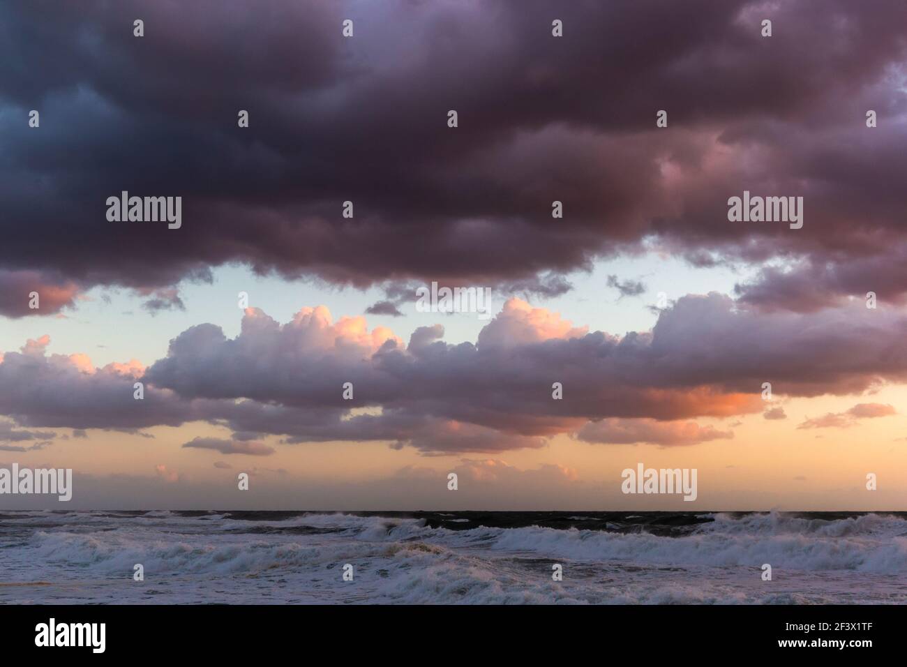 Cloudy sunset at the stormy sea Stock Photo - Alamy