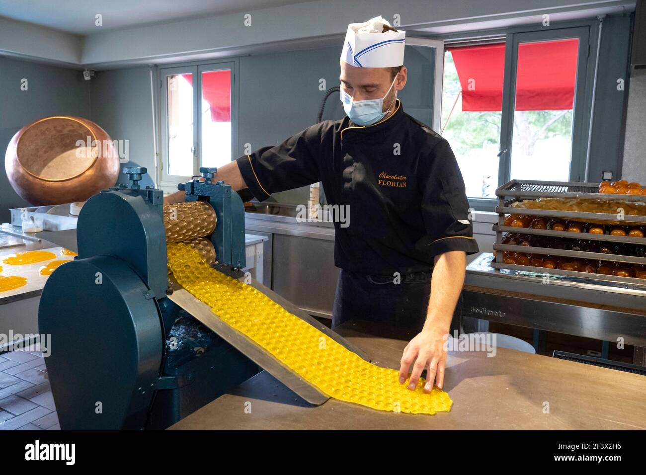 Confectionery, candy making at the candy store “Confiserie Florian” in Nice (south-eastern France), traditional production. The dough is shaped to mak Stock Photo