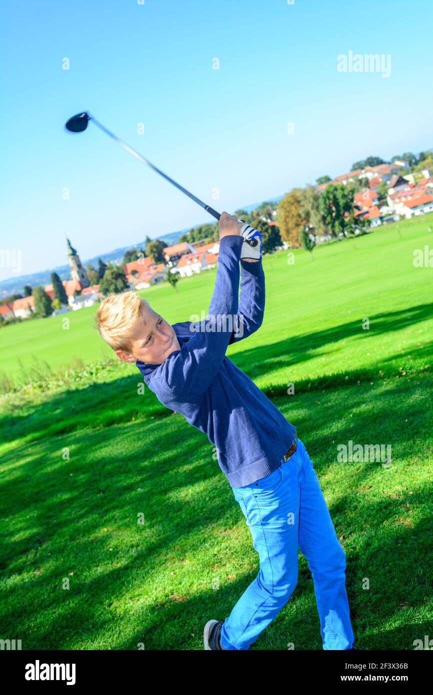 Talented young golfers playing ambitiously on a golf course. Stock Photo