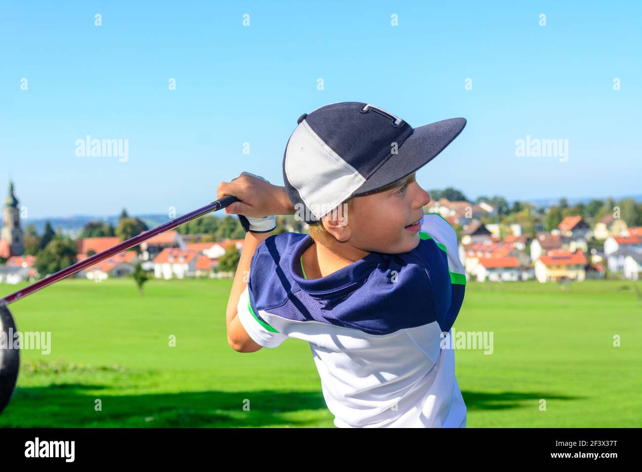 Talented young golfers playing ambitiously on a golf course. Stock Photo