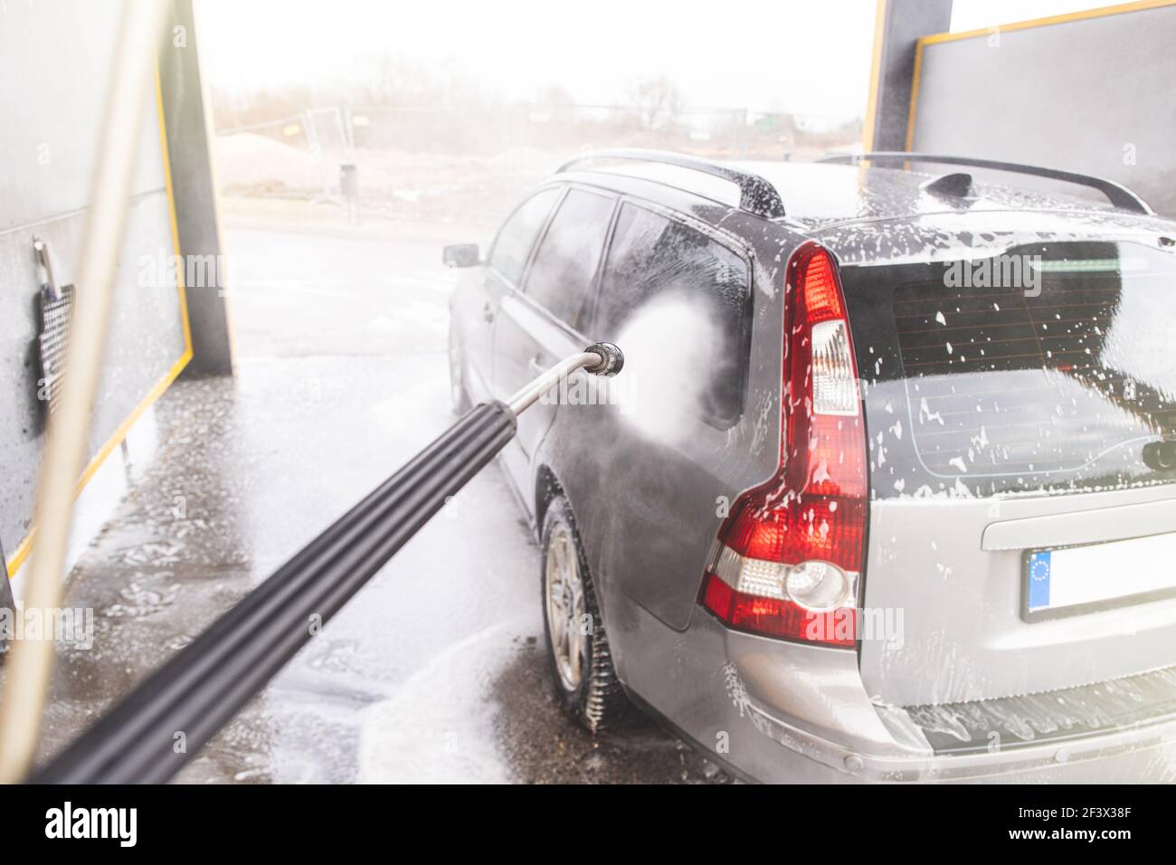 Contactless  car wash self service system. Washing dirty car in car wash station with foam Stock Photo