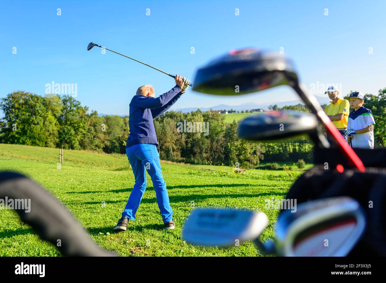 Talented young golfers playing ambitiously on a golf course. Stock Photo