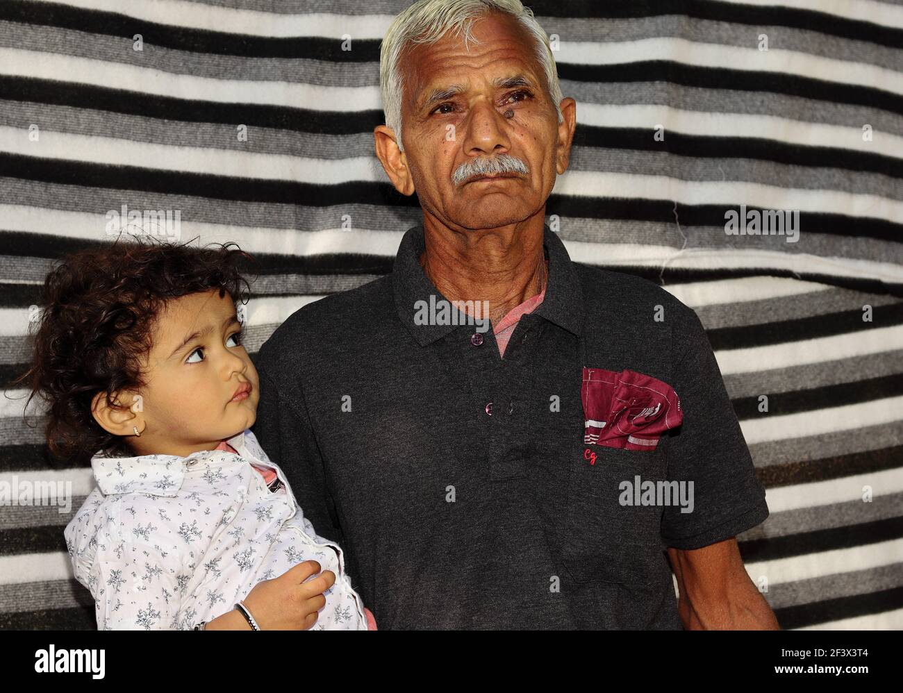 portrait-photo-of-an-indian-senior-grandfather-and-younger-grandson