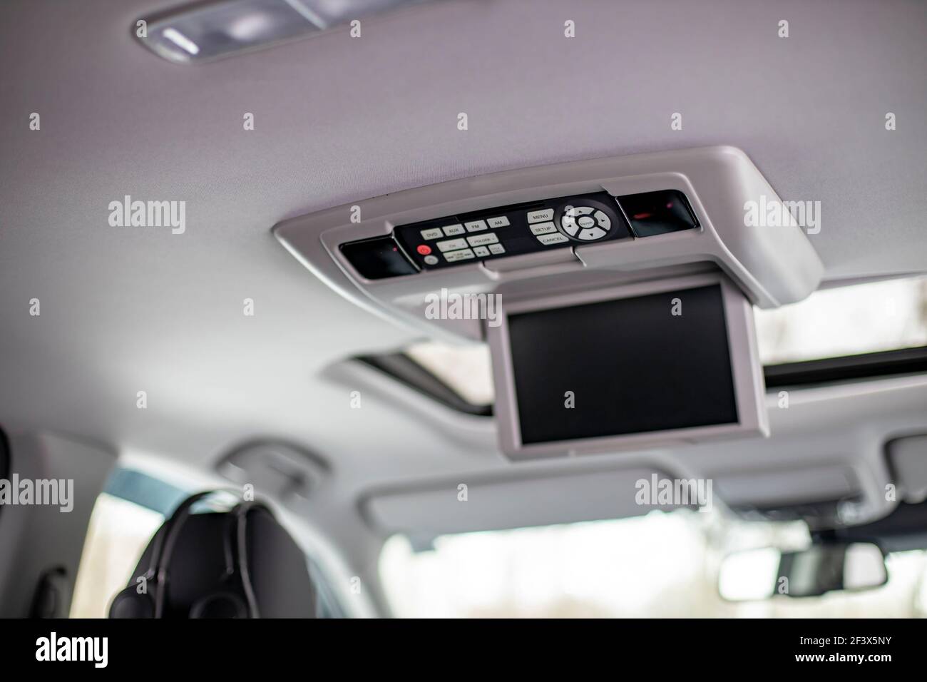 MOSCOW, RUSSIA - FEBRUARY 2, 2020: Rear passenger multimedia system on the ceiling in the interior of the new 3rd generation Honda Pilot SUV. Stock Photo