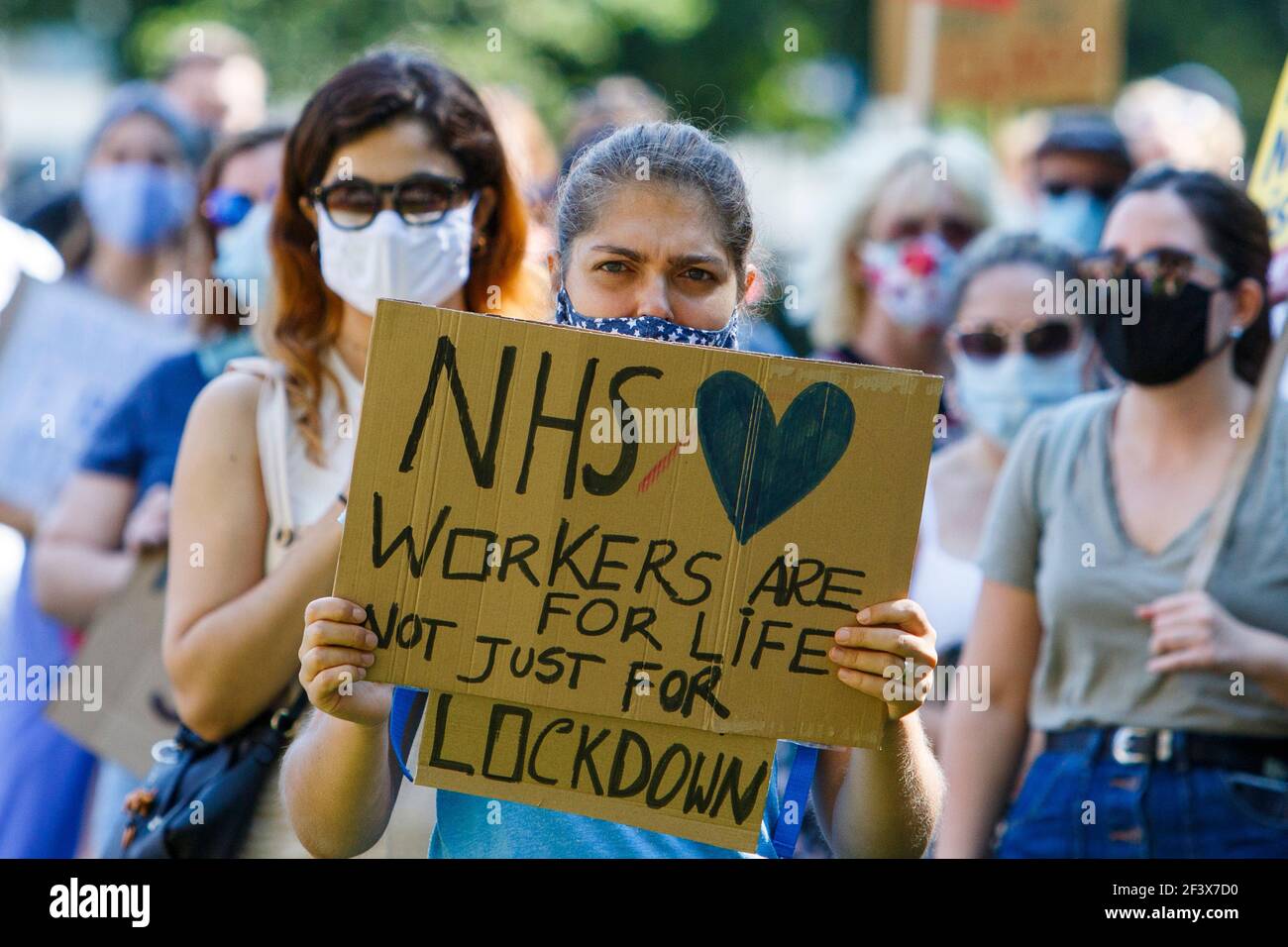 Placard carrying protesters are pictured as they take part in an NHS workers ‘pay justice’ demonstration and protest march in Bristol, 8th August 2020 Stock Photo