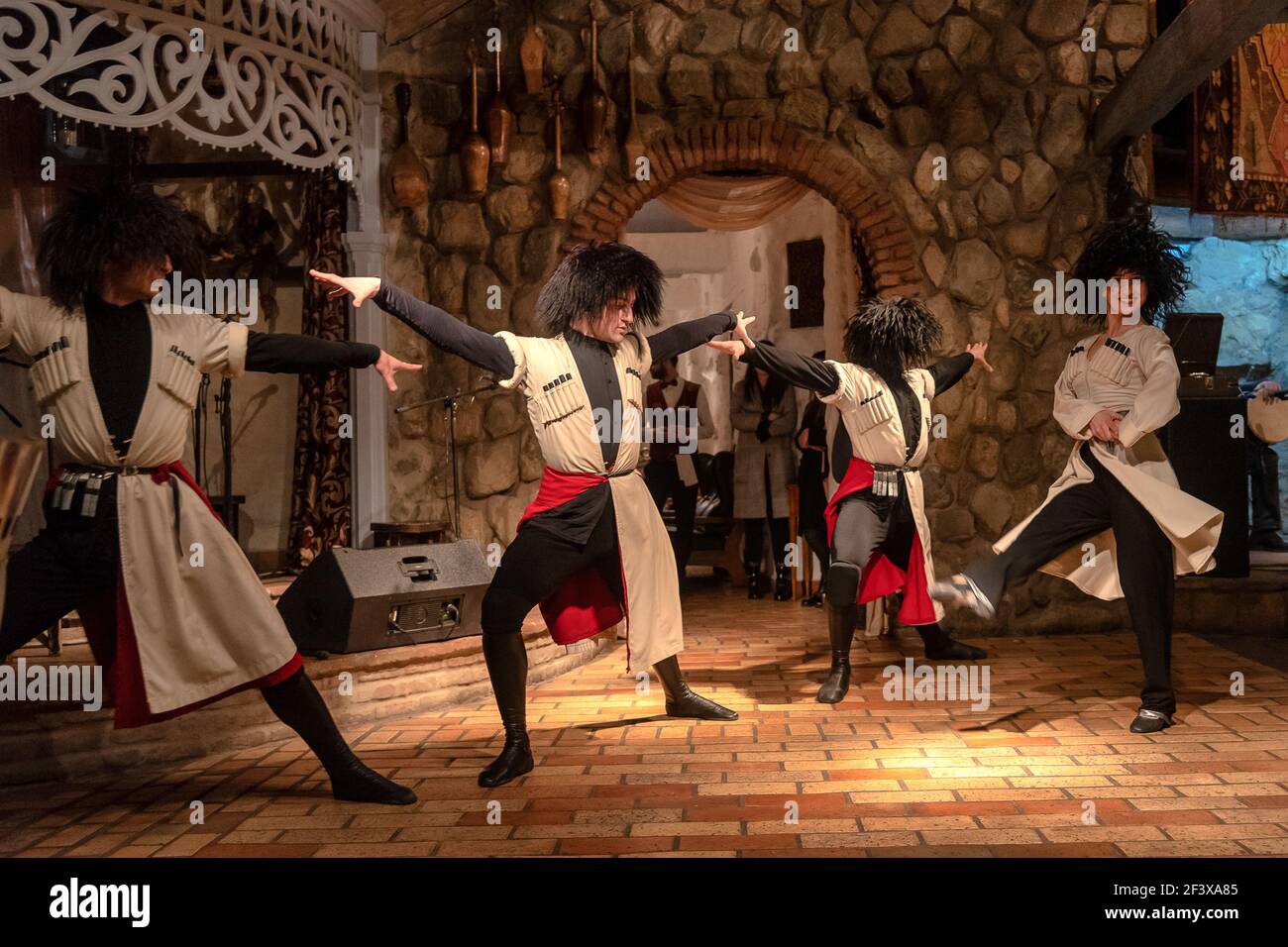 Georgian dancers dancing a folklore dance show on stage in Tbilisi, Georgia. It's a mountain dance that best representative of the Georgian people Stock Photo