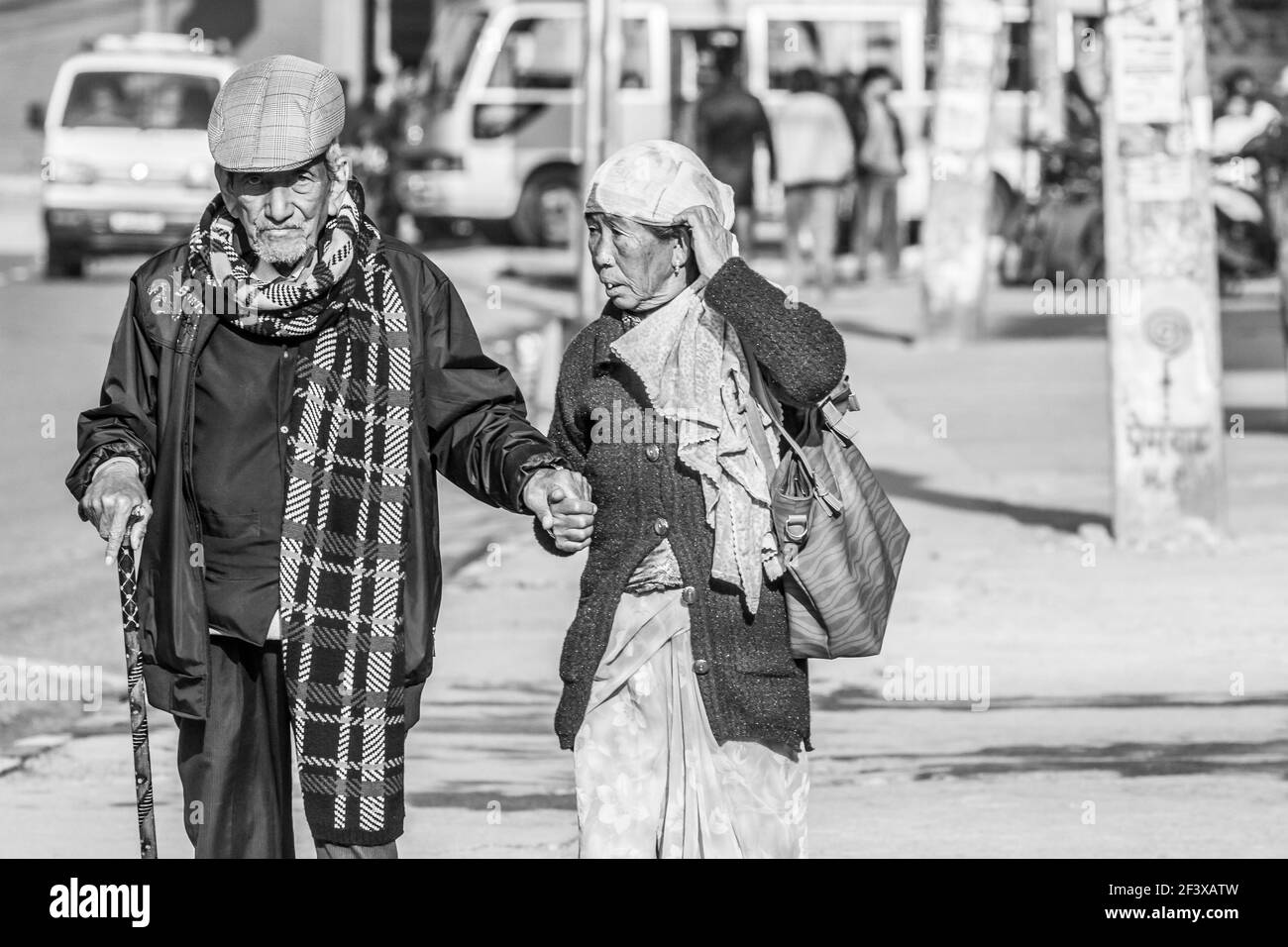 Pokhara, Nepal - November 21, 2015: Elderly couple walking on the street in Pokhara, Nepal Stock Photo
