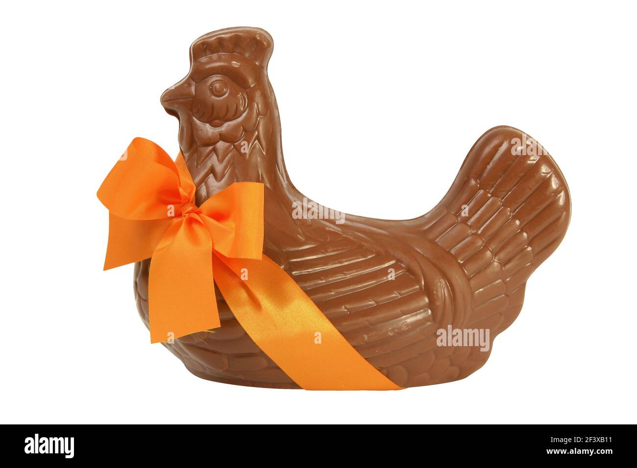 Chocolate Easter hen with orange ribbon, cut out and isolated on a white background - Stock Image