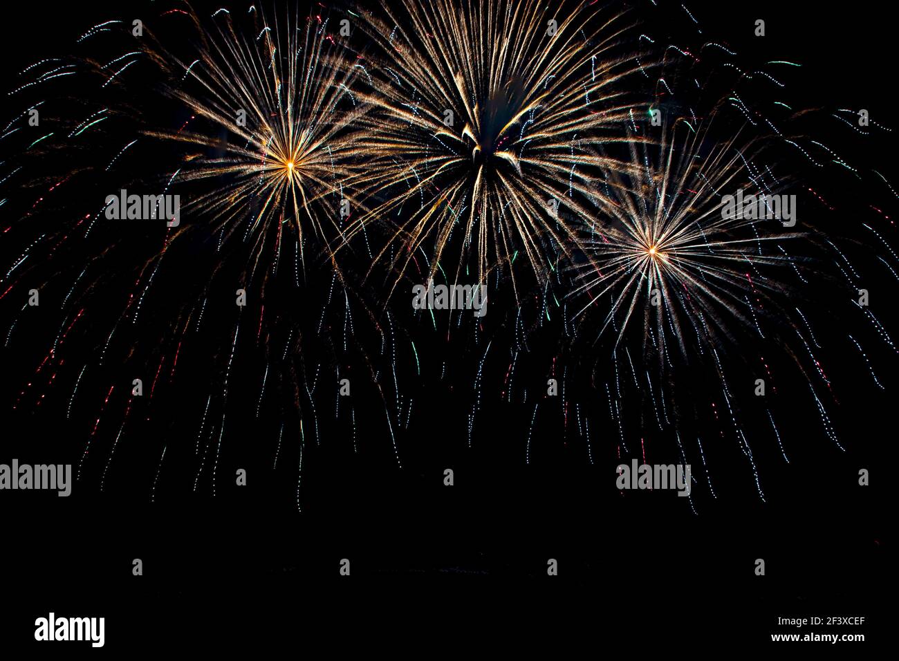 Delicate gold fireworks in a night sky. Isolated on black. Stock Photo