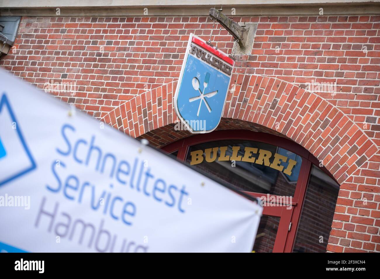 Hamburg, Germany. 18th Mar, 2021. A poster with the inscription 'Schnelltest Service Hamburg' stands in front of the 'Bullerei'. In the restaurant 'Bullerei' of the Hamburg restaurateur and TV chef Mälzer, Hamburgers can get tested for the corona virus free of charge. Credit: Jonas Walzberg/dpa/Alamy Live News Stock Photo