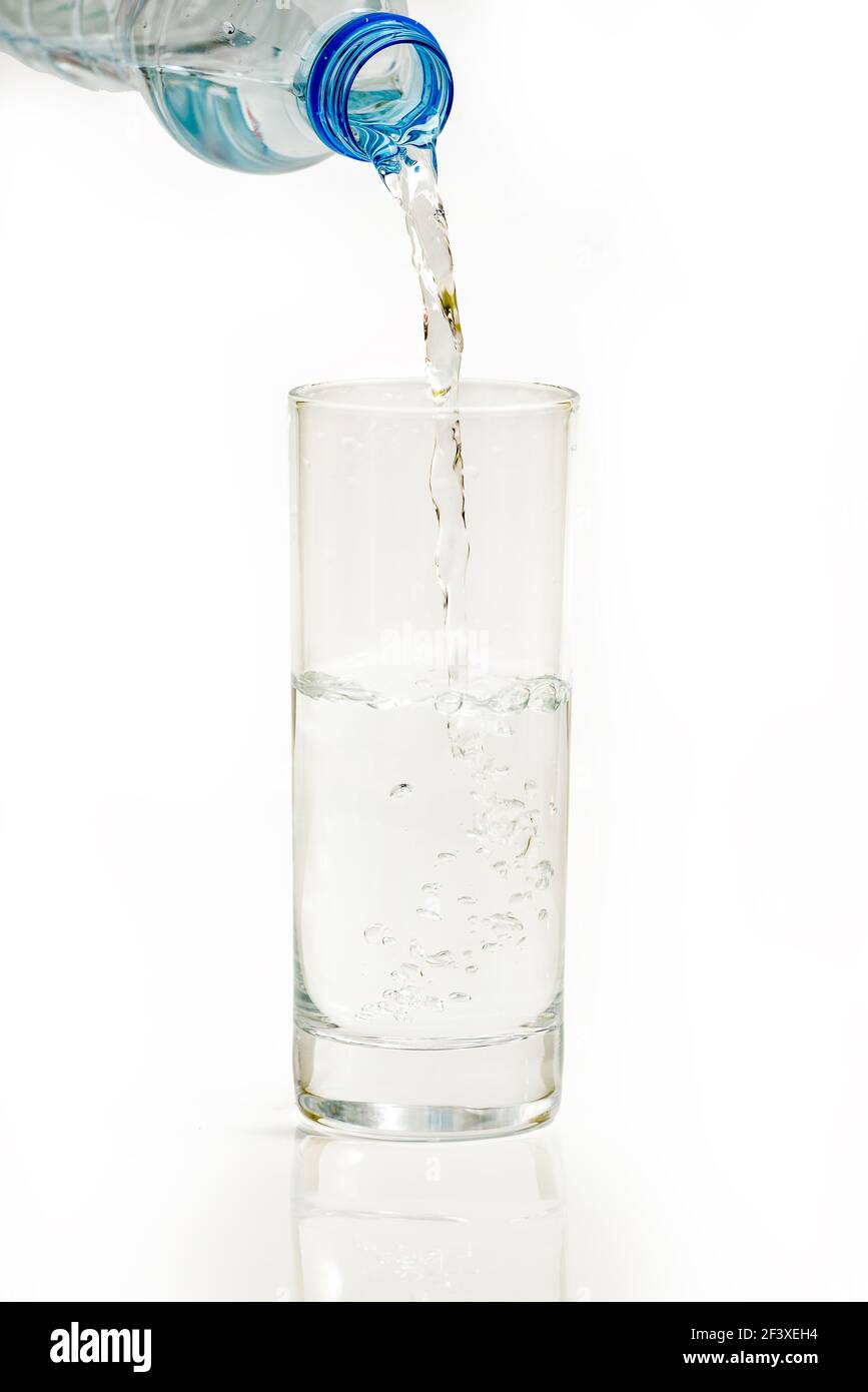 Water bottle pour water to glass on white background Stock Photo Alamy