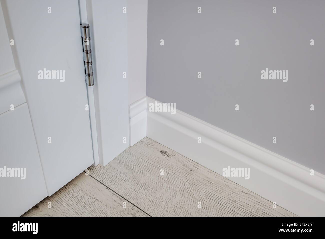 Detail of corner flooring with intricate crown molding and plinth Stock