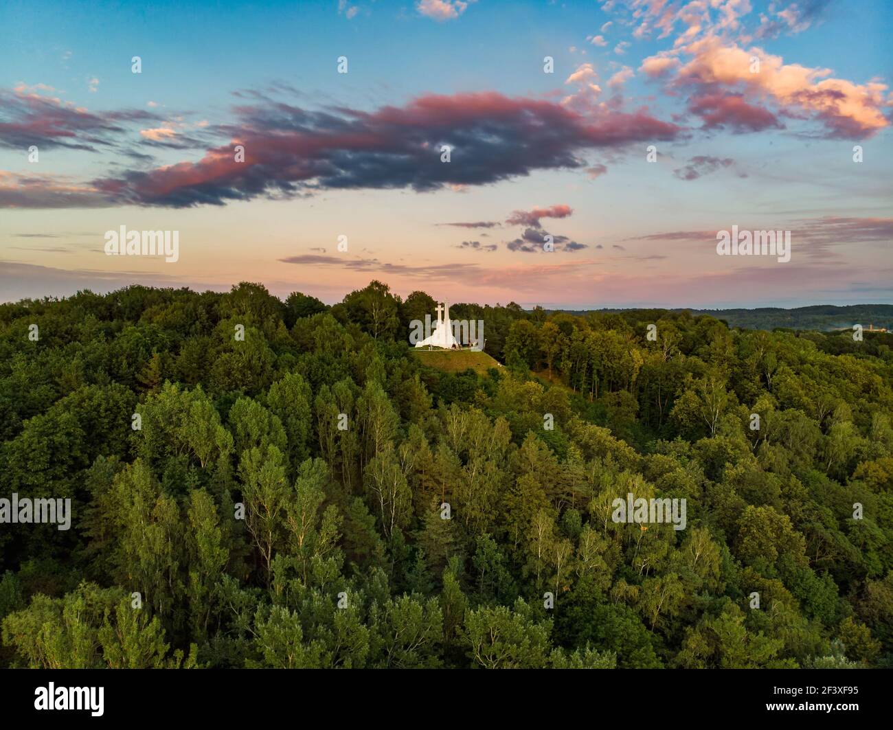 Aerial view of the Three Crosses monument overlooking Vilnius Old Town on sunset. Vilnius landscape from the Hill of Three Crosses, located in Kalnai Stock Photo