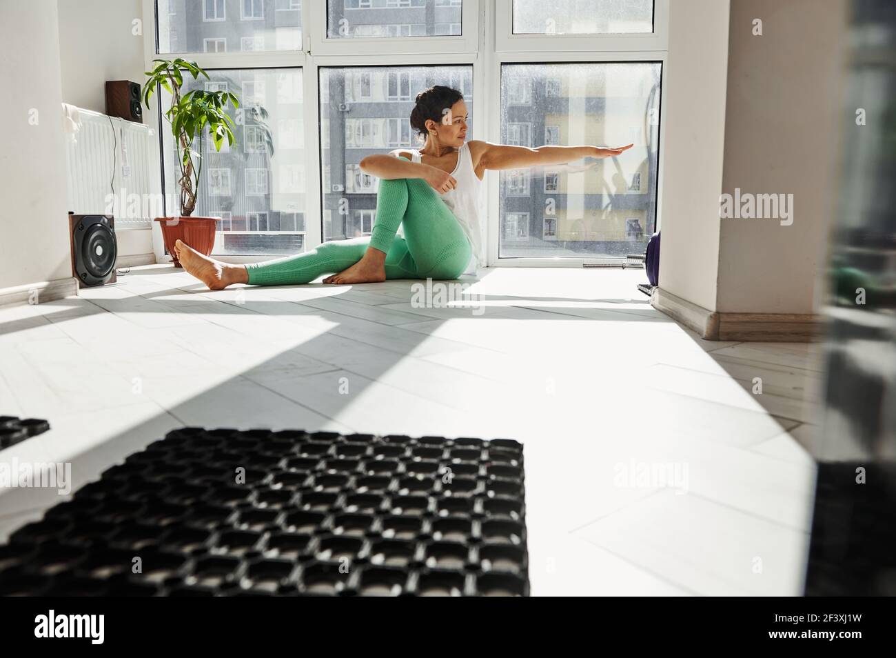 Healthy woman sitting on the floor practicing and performing yoga ...