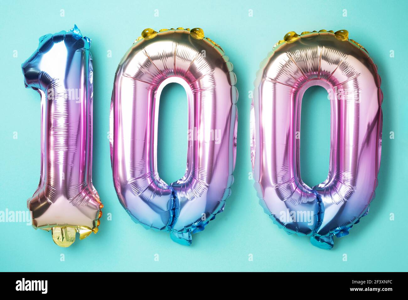 Rainbow foil balloon number, digit one hundred. Birthday greeting card with  inscription 100. Anniversary concept. Top view. Colored numeral on blue  Stock Photo - Alamy