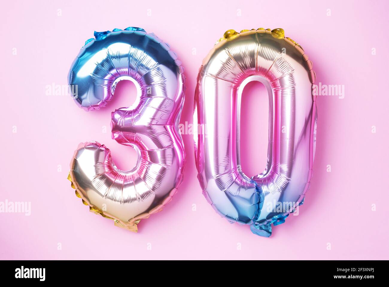 Rainbow foil balloon number, digit thirty. Birthday greeting card with  inscription 30. Anniversary concept. Top view. Colored numeral on pink  Stock Photo - Alamy