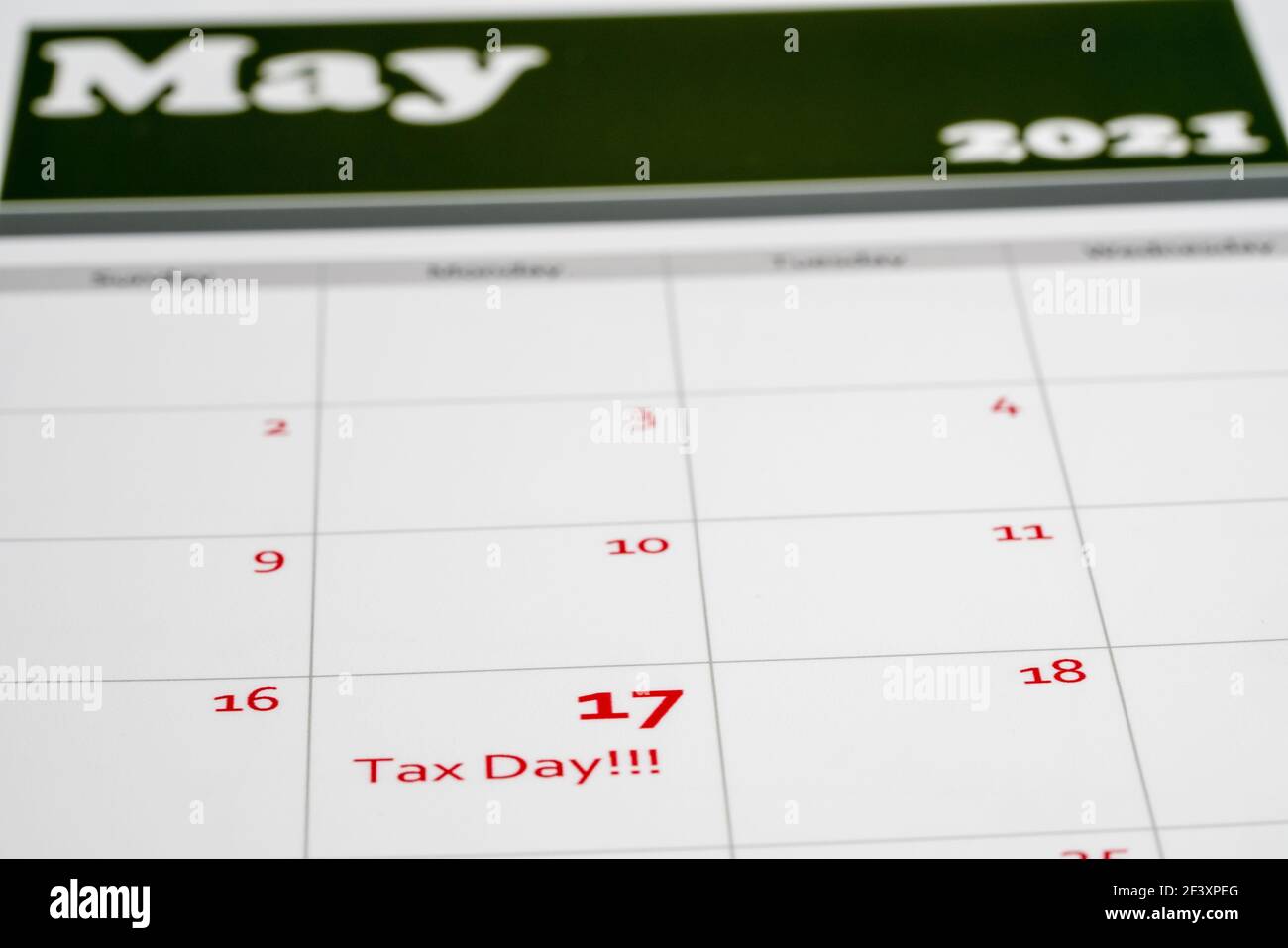 Calendar with Tax Day note inserted in the date for May 17 to illustrate the new tax return filing date of 17th May 2021. Stock Photo