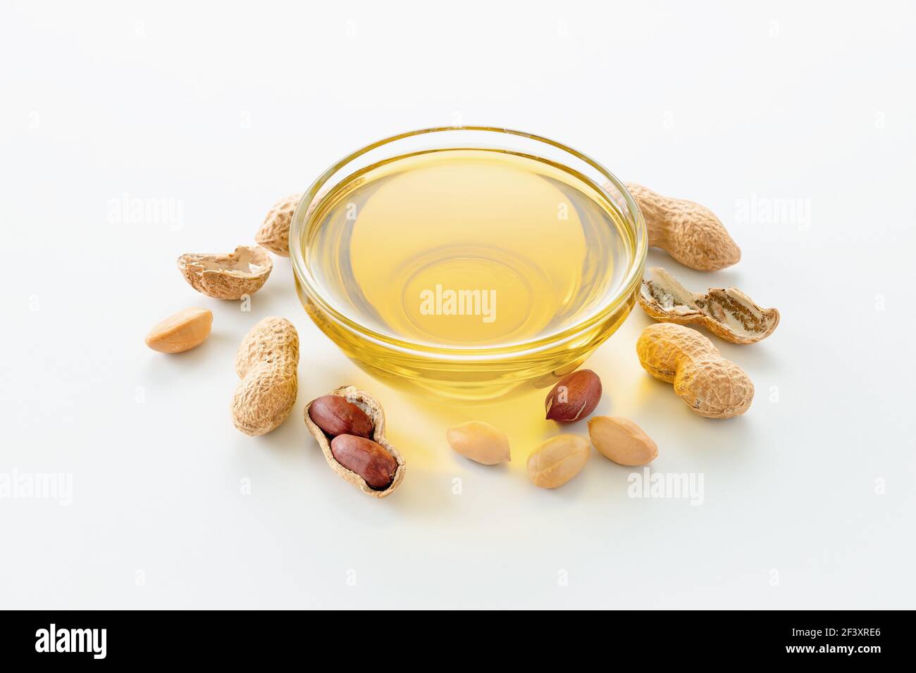 Natural peanut oil in a bowl with peanuts Stock Photo