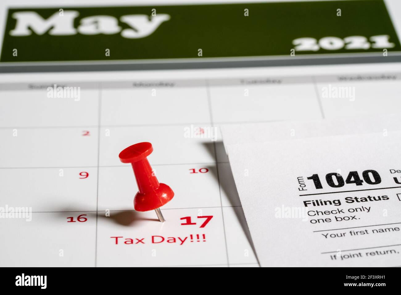 Calendar with Tax Day note inserted in the date for May 17 to illustrate the new tax return filing date of 17th May 2021. Stock Photo