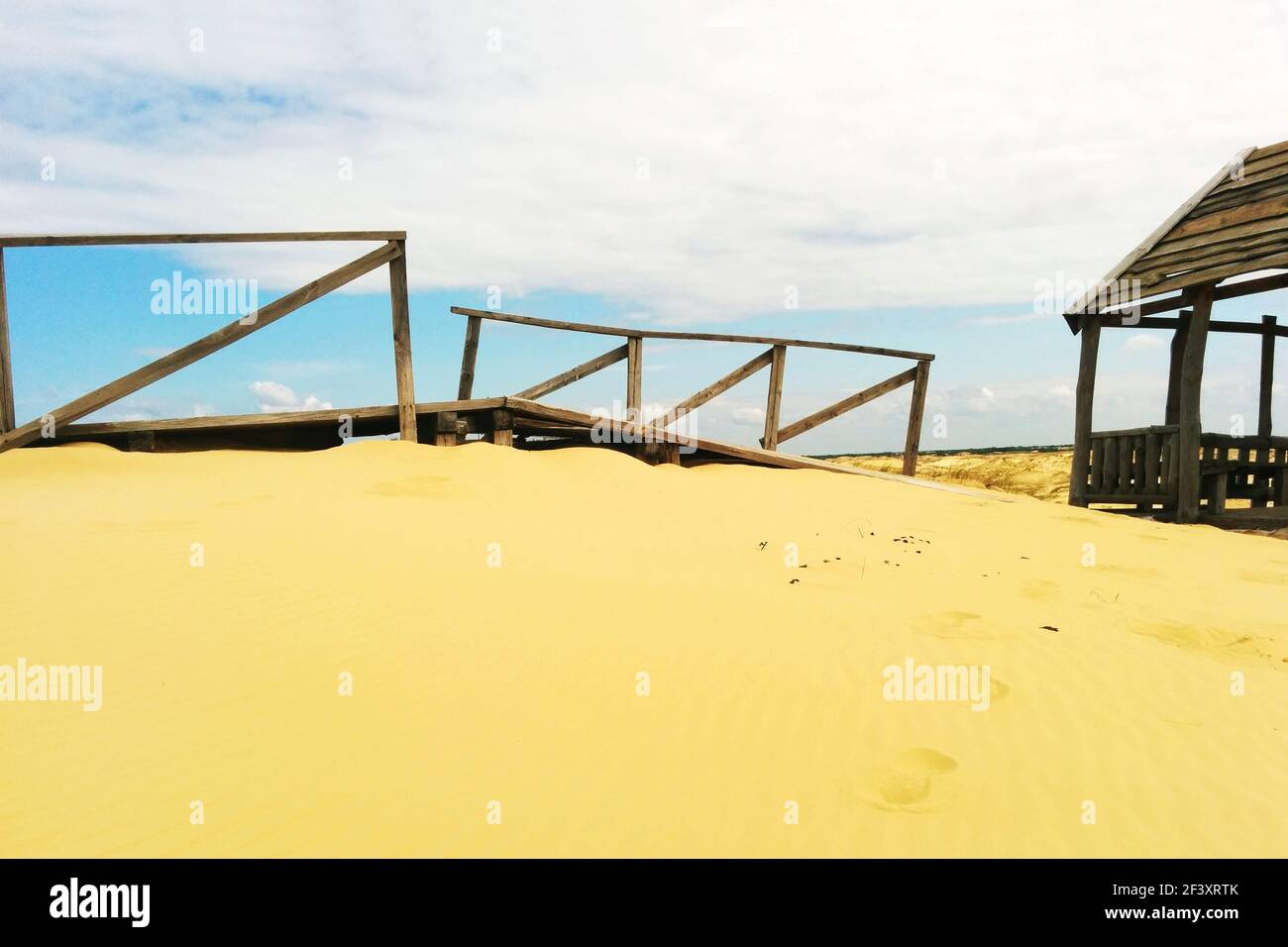 Desert landscape. Wooden structures on sand Stock Photo - Alamy