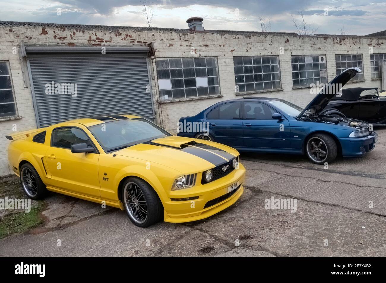2005 Ford Mustang GT and BMW M5 on display at Lenwade Industrial Estate, Norfolk, UK. Stock Photo