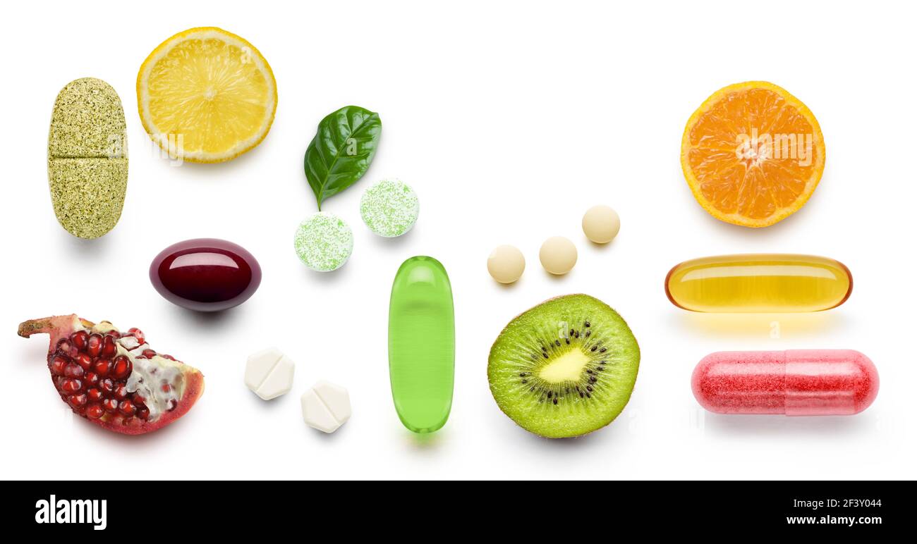 various vitamin supplement pills with citrus fruits on white background Stock Photo